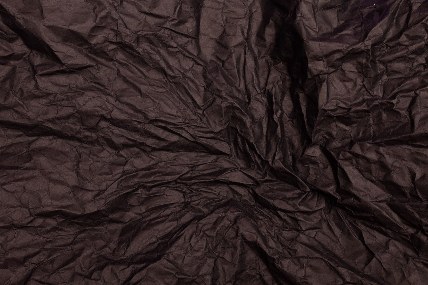 A textured crumpled brown paper surface perfect for design projects.